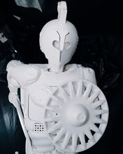 Load image into Gallery viewer, Front detail of Plastic Apocalypse – Trojan Warrior, featuring its helmet, armour and circular shield made from reclaimed plastic components.