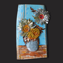 Load image into Gallery viewer, Sunflowers III by Scoobafish, contemporary mixed-media artwork made with recycled metal and found materials, featuring three sculptural sunflowers in a metal vase on a blue and rust-toned background.