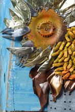 Load image into Gallery viewer, Close-up of Sunflowers III by Scoobafish, highlighting a rusted sunflower centre, layered recycled-metal petals and part of a second textured flower on a blue painted panel.