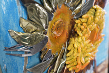 Load image into Gallery viewer, Side close-up of Sunflowers III by Scoobafish, highlighting layered recycled-metal petals, rusted components and textured sunflower forms on a blue painted panel.