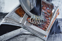 Load image into Gallery viewer, Close-up of layered metal fragments, weathered surfaces and aluminium can tabs forming details of Black Jug and Skull by Scoobafish.