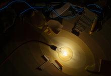 Carica l'immagine nel visualizzatore di Gallery, Close-up bioluminescent light detail - recycled plastic deep-sea creature sculpture with golden glow