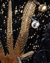 Load image into Gallery viewer, Close-up of gilded branches, embossed metal leaves and reflective found objects against the black background of Judith by Scoobafish.