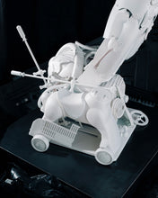 Load image into Gallery viewer, Detail of the base and lower body of Plastic Apocalypse – Trojan Warrior, assembled from discarded plastic objects and household components.
