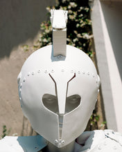 Load image into Gallery viewer, Front close-up of the white helmet and face of Plastic Apocalypse – Trojan Warrior photographed outdoors in Sardinia.

