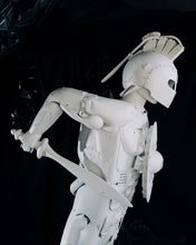 Load image into Gallery viewer, Side profile of Plastic Apocalypse – Trojan Warrior, showing the helmet, torso, shield and spear constructed from reclaimed objects.
