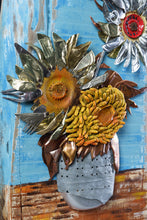 Load image into Gallery viewer, Detail of Sunflowers III by Scoobafish, showing three sculptural sunflower heads made from recycled metal and found materials against a blue painted background.
