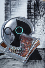 Load image into Gallery viewer, Close-up of the skull in Black Jug and Skull by Scoobafish, formed from a metal lid, can tabs and weathered reclaimed components.
