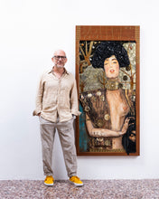 Load image into Gallery viewer, Full-body view of artist Scoobafish standing beside Judith on a white wall, clearly showing the artwork’s height and proportions.
