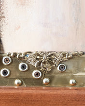 Load image into Gallery viewer, Close-up of the lower section of Judith by Scoobafish, featuring decorative metalwork, screws, studs and the wooden frame.
