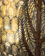 Load image into Gallery viewer, Close-up of embossed metal leaves and overlapping aluminium lids forming the golden background of Judith by Scoobafish.
