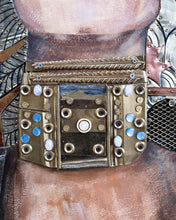 Load image into Gallery viewer, Close-up of Judith’s geometric metal necklace by Scoobafish, decorated with screws, rings and blue reflective elements.
