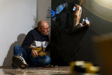 Load image into Gallery viewer, Artist working on installation - Maurizio Sergiusti creating bioluminescent plastic fish sculpture
