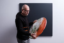 Carica l&#39;immagine nel visualizzatore di Gallery, Maurizio Sergiusti Scoobafish artist holding and examining rotten orange sculpture
