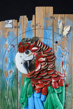 Load image into Gallery viewer, Close-up of the head and upper body of Proud Parrot by Scoobafish, showing layered red feathers and reclaimed components on painted wood.
