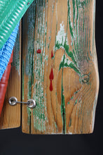Load image into Gallery viewer, Close-up of the weathered wooden boards of Proud Parrot by Scoobafish, showing green paint, red drips and a metal fastener.
